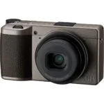 Compact digital camera with lens, ideal for photography enthusiasts in the UK.