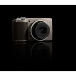 Compact digital camera with sleek design on black background, available at Camix UK.