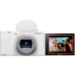 Sony digital camera with flip screen displaying a group photo, available at Camix UK.