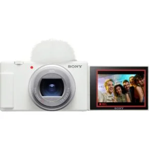 Sony digital camera with flip screen displaying a group photo, available at Camix UK.