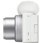 Compact digital camera with a fluffy microphone, ideal for vlogging and photography.