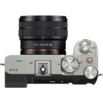 Top view of a Sony mirrorless camera with lens, featuring control dials and buttons.