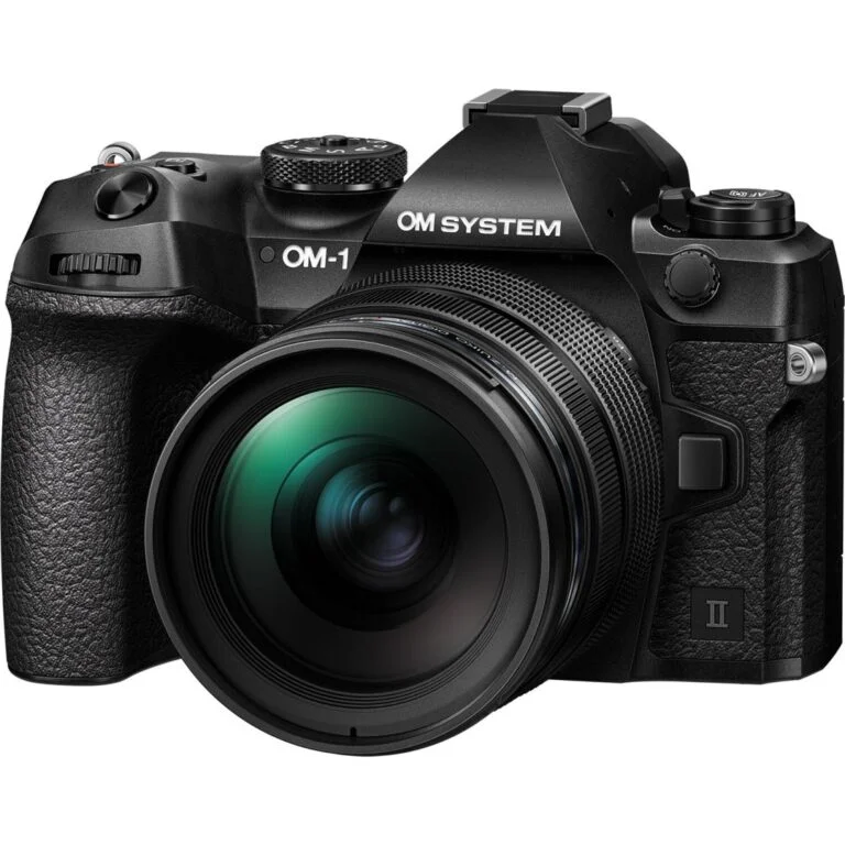 OM System mirrorless camera with lens, available at Camix UK.