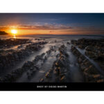 Sunset over rocky shoreline captured with professional camera gear.