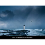 Stormy seascape with lighthouse and dramatic sky