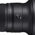 Close-up of a camera lens with a lock switch, ideal for photography enthusiasts.