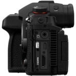 Side view of a professional digital camera with multiple ports and controls.