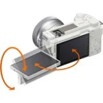 White mirrorless camera with tilting screen, ideal for photography enthusiasts.