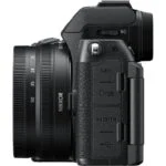 Side view of a Nikon mirrorless camera with lens, featuring HDMI and USB ports.
