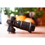 Nikon Z camera with Sigma lens on wooden surface in camera shop UK.