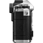 Side view of a mirrorless camera body with textured grip and control dials.