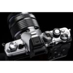 Top view of a mirrorless camera with a 12-45mm lens, showcasing dials and controls.