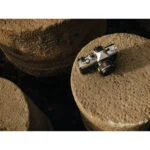 Mirrorless camera on stone surface, ideal for photography enthusiasts.