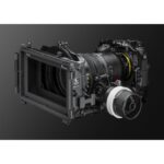Professional cinema camera with lens and accessories on display.