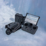 DJI drone with controller and battery pack on icy surface, available at Camix UK.