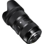 Sigma zoom lens for DSLR cameras with lens hood, available at Camix camera shop UK.