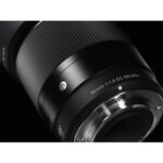 Close-up of a Sigma 30mm f/1.4 DC DN lens for mirrorless cameras.