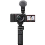 Sony mirrorless camera with microphone and grip, ideal for vlogging and photography.