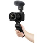 Sony mirrorless camera with microphone and grip, ideal for vlogging and professional use.