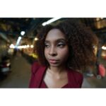 Portrait of a person in a dimly lit urban setting, captured with a wide-angle lens.