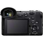 Back view of a digital mirrorless camera with LCD screen and controls.