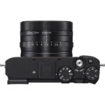 Top view of a compact digital camera with control dials and lens, ideal for photography enthusiasts.