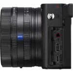 Side view of a Sony mirrorless camera with lens and ports visible.