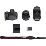 Canon EOS camera kit with two lenses, battery, charger, and strap.