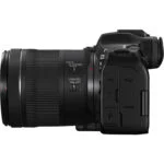 Side view of a Canon mirrorless camera with lens, featuring focus control and stabilizer switches.