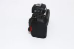 Side view of a Canon DSLR camera body with control dials, ideal for photography enthusiasts.