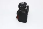 Side view of a Canon DSLR camera body with control dials, ideal for photography enthusiasts.