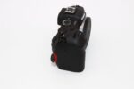 Canon DSLR camera body with control dial on white background