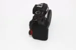 Canon DSLR camera body with control dial on white background