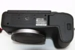 Close-up of a Canon camera body showing the bottom view with model details.