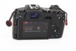 Back view of a digital camera with settings displayed on the screen, available at Camix camera shop UK.
