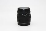 Sigma camera lens on white background, ideal for photography enthusiasts.