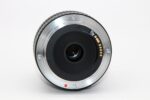Close-up of a camera lens mount, showcasing electronic contacts and lens elements.
