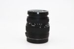 Sigma camera lens on white background, ideal for photography enthusiasts.