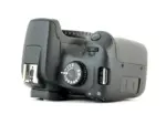 Digital camera body with control dial and USB port, ideal for photography enthusiasts.