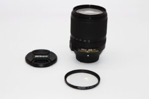 Nikon DX VR lens with cap and UV filter on white background, available at Camix camera shop UK.