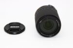 Nikon camera lens with cap, ideal for DSLR and mirrorless cameras.