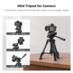Mini tripod for cameras with 3-way pan head on a table.