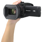 Panasonic 4K camcorder held in hand, ideal for professional video recording.