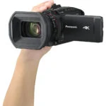 Panasonic 4K camcorder held in hand, ideal for professional video recording.