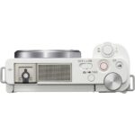 Top view of a compact mirrorless camera with control dials and buttons.