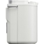 Side view of a white compact digital camera body with textured grip.