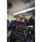Professional videographer using a cinema camera setup on location.