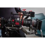 Professional cinema camera setup with Canon lens and accessories.