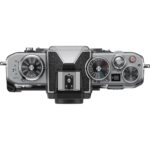 Top view of a silver digital camera body with control dials, available at Camix UK.