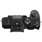 Top view of a Sony mirrorless camera body with control dials and buttons.
